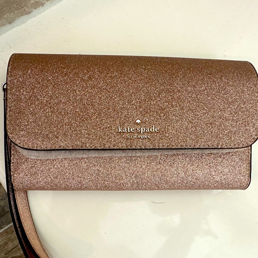 Rose gold Kate spade wristlet. Brand new. Don't have receipt it was a gift